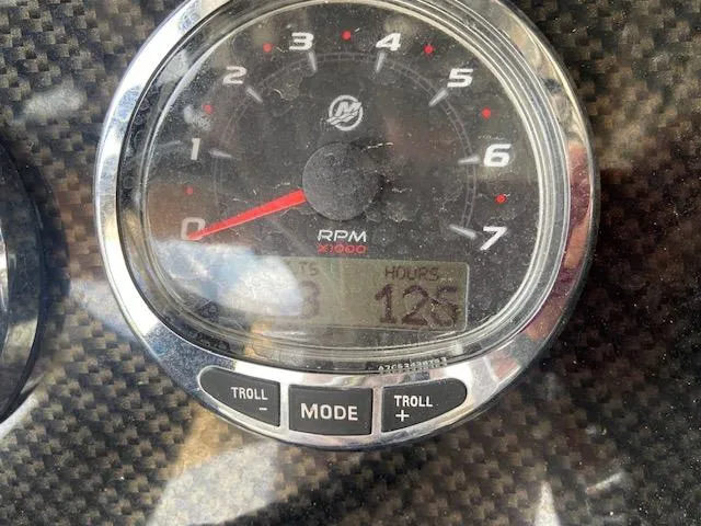 Slide: The Image of Close-up of 2014 ShearWater 26 Carolina boat tachometer showing 125 hours. - 27