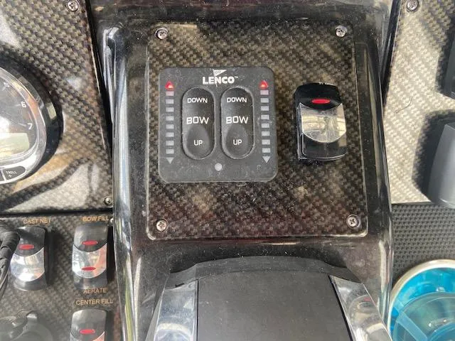 Slide: The Image of Control panel of a 2014 ShearWater 26 Carolina boat with Lenco trim tab switches. - 28