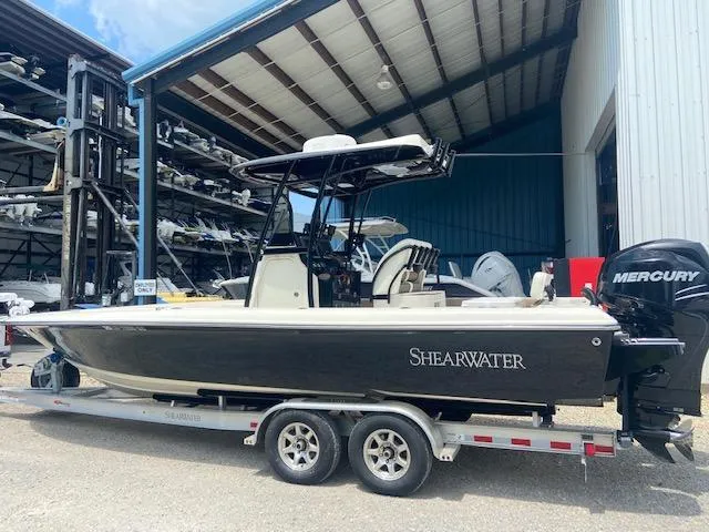 Slide: The Image of 2014 ShearWater 26 Carolina boat on a trailer, docked at a marina. - 3