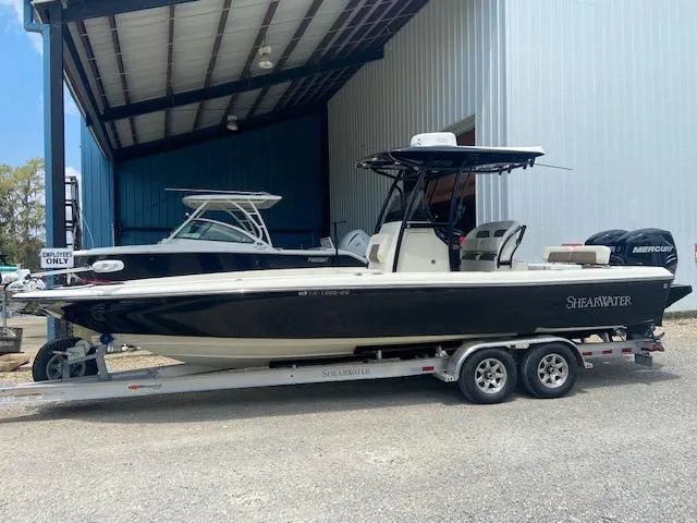 Slide: The Image of 2014 ShearWater 26 Carolina boat on a trailer in a storage facility. - 5