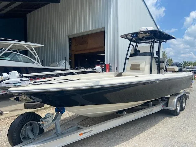 Slide: The Image of 2014 ShearWater 26 Carolina boat on a trailer outside a storage facility. - 6