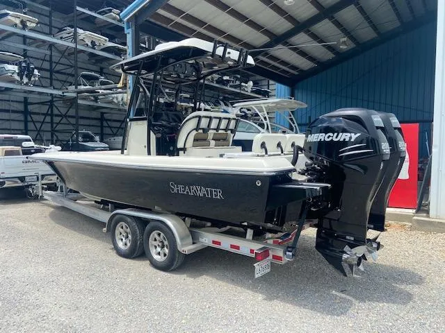 Slide: The Image of 2014 ShearWater 26 Carolina boat on trailer with dual Mercury engines in storage facility. - 7