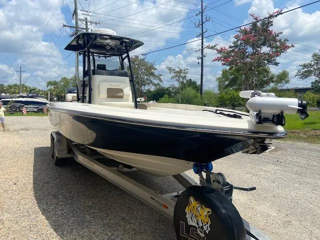 Slide: The Image of 2014 ShearWater 26 Carolina boat on trailer, black and white hull, outdoor setting. - 9