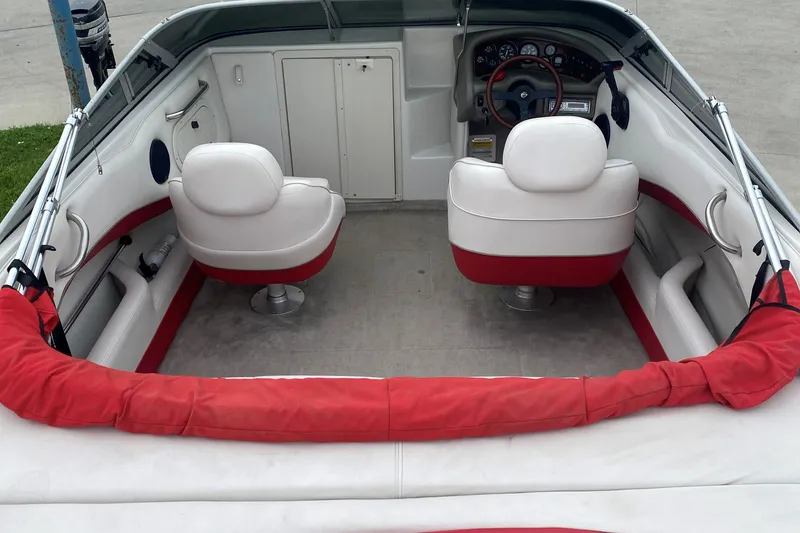 Slide: The Image of 1998 Crownline 202 CC boat interior with white and red seating. - 2