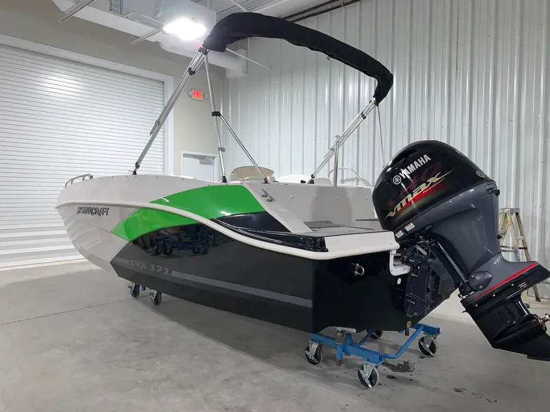 Slide: The Image of 2024 Starcraft SVX 171 boat with Yamaha outboard motor in a storage facility. - 2