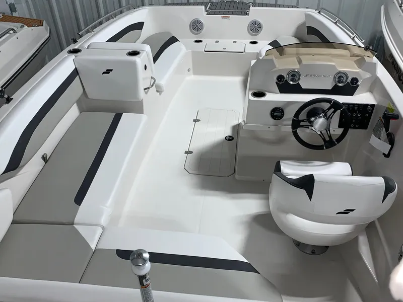 Slide: The Image of 2024 Starcraft SVX 171 boat interior with white and gray seating and steering console. - 7