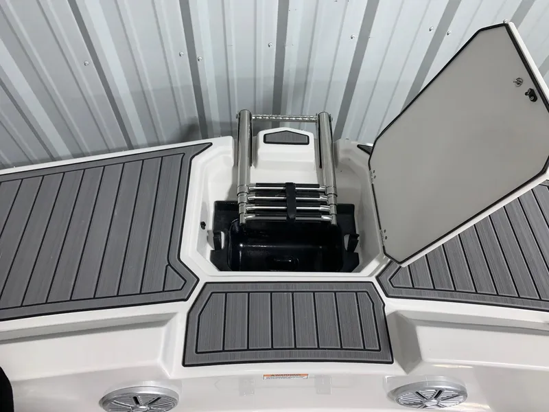 Slide: The Image of 2024 Starcraft SVX 171 boat with open storage compartment and ladder. - 9