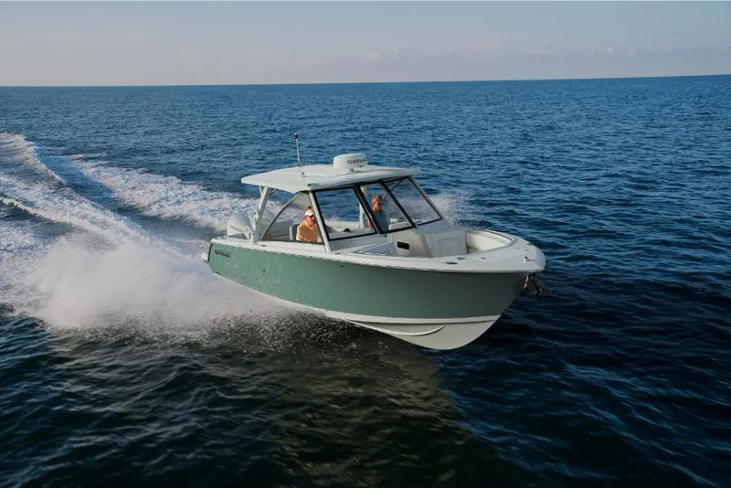Slide: The Image of 2023 Sailfish 316 DC boat cruising on open water. - 0