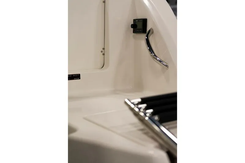 Slide: The Image of 2023 Sailfish 316 DC boat interior detail with control panel and chrome handle. - 12