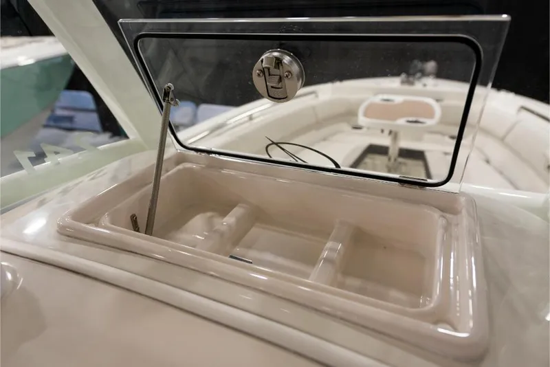 Slide: The Image of 2023 Sailfish 316 DC boat storage compartment with open lid. - 14
