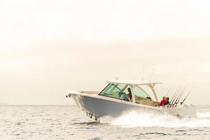 Slide: The Image of 2023 Sailfish 316 DC boat cruising on open water. - 3