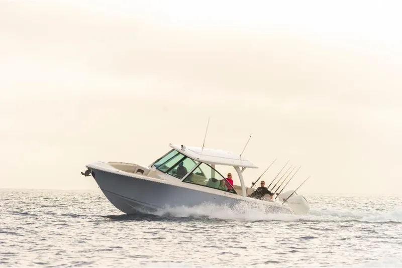 Slide: The Image of 2023 Sailfish 316 DC boat cruising on open water. - 30