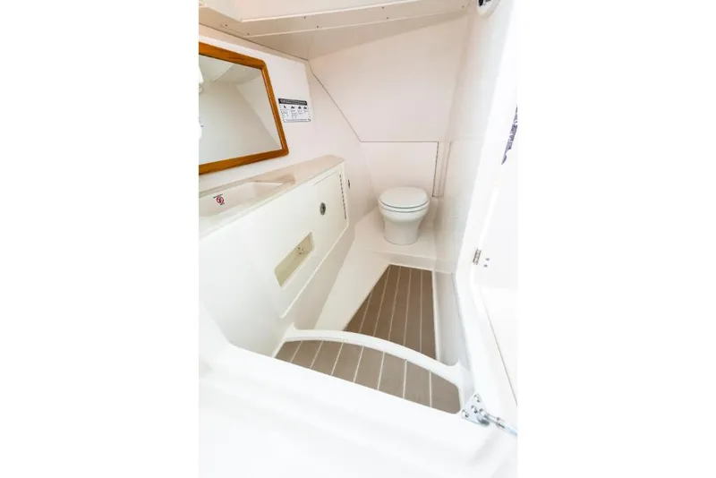 Slide: The Image of 2023 Sailfish 316 DC boat interior bathroom with toilet and sink. - 33