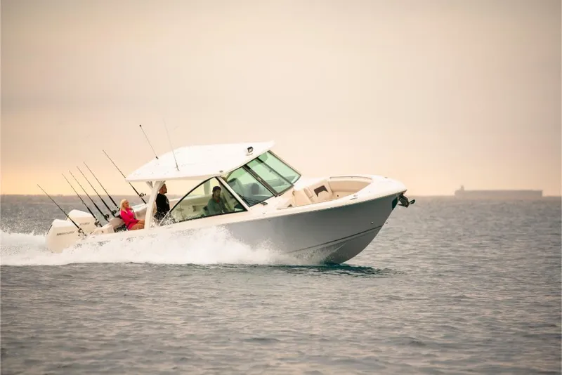 Slide: The Image of 2023 Sailfish 316 DC boat cruising on open water. - 35