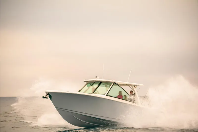 Slide: The Image of 2023 Sailfish 316 DC boat cruising on open water. - 36