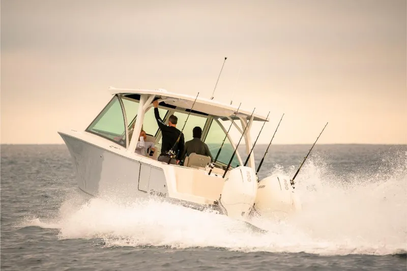 Slide: The Image of 2023 Sailfish 316 DC boat cruising on open water. - 37