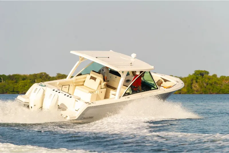 Slide: The Image of 2023 Sailfish 316 DC boat cruising on open water. - 4