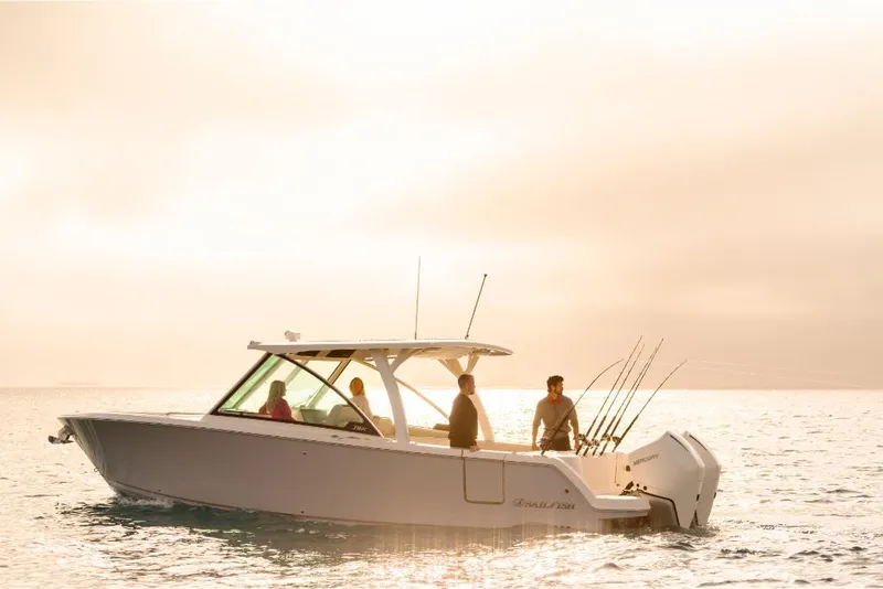 Slide: The Image of 2023 Sailfish 316 DC boat cruising on calm waters at sunset. - 40