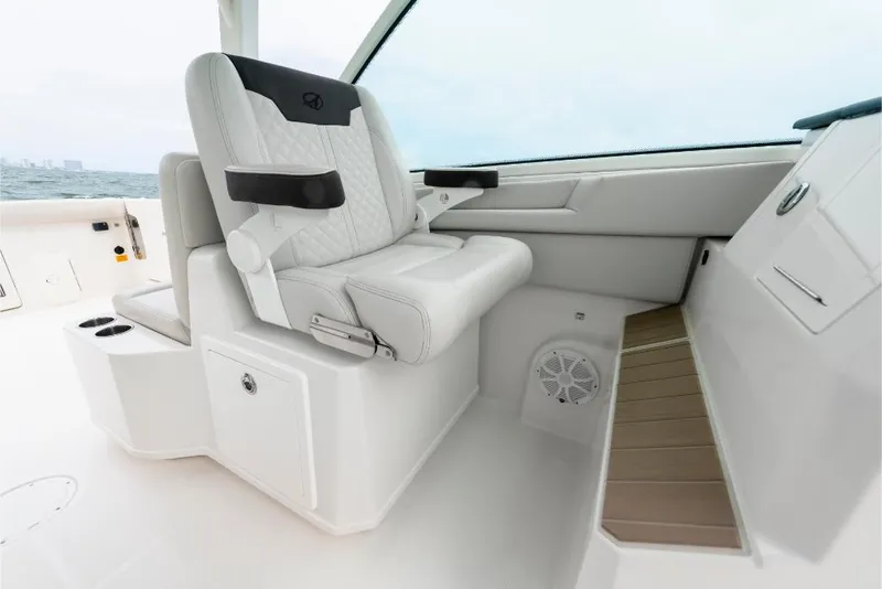 Slide: The Image of Luxury seating on 2023 Sailfish 316 DC boat with white upholstery and armrests. - 48