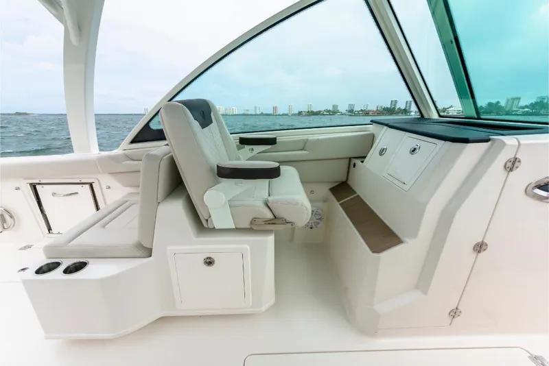Slide: The Image of 2023 Sailfish 316 DC boat interior with seating and storage compartments. - 49