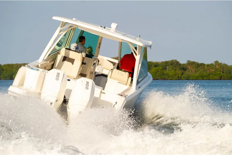 Slide: The Image of 2023 Sailfish 316 DC boat cruising on water with twin outboard engines. - 5