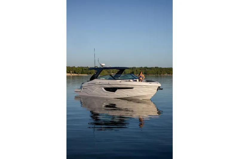 Slide: The Image of 2023 Cruisers Yachts 34 GLS I/O on calm water with a person onboard. - 13
