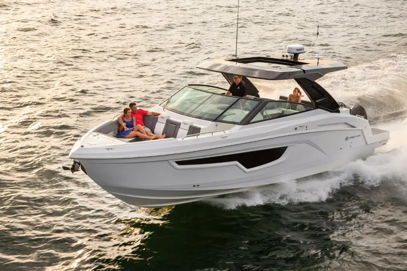 Slide: The Image of 2023 Cruisers Yachts 34 GLS I/O cruising on water with passengers onboard. - 2