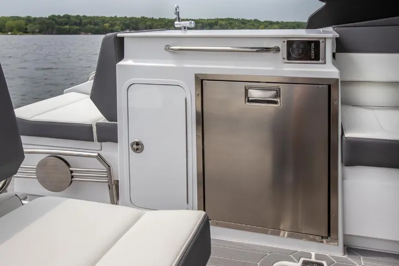 Slide: The Image of 2023 Cruisers Yachts 34 GLS I/O interior with stainless steel fridge and storage compartment. - 24