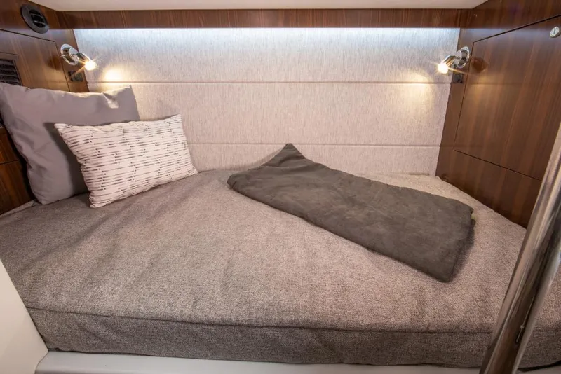 Slide: The Image of 2023 Cruisers Yachts 34 GLS I/O cabin bed with modern lighting and cozy bedding. - 37