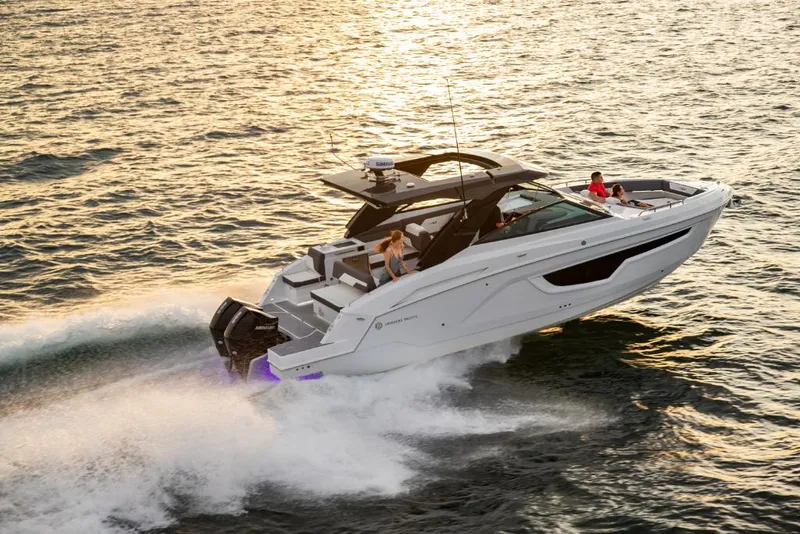 Slide: The Image of 2023 Cruisers Yachts 34 GLS I/O speeding on water at sunset. - 5