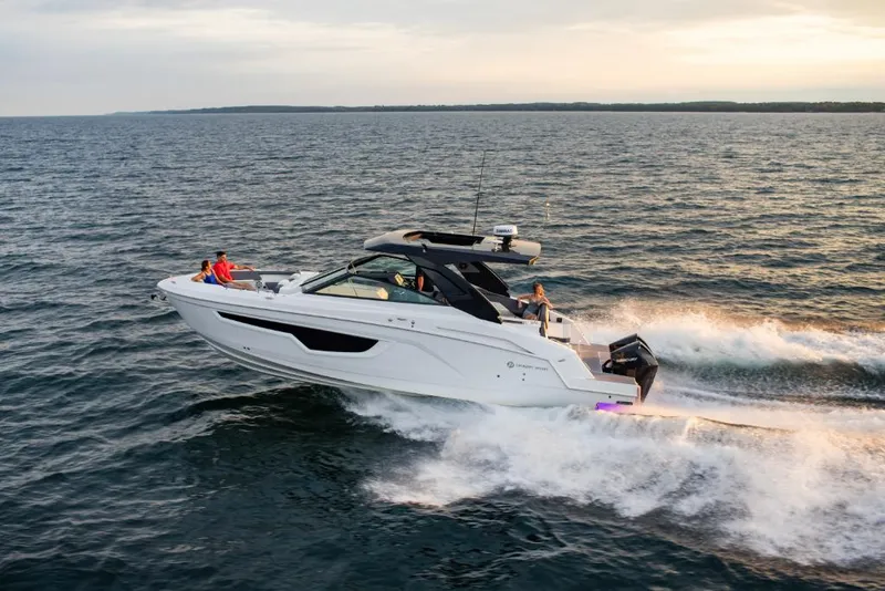 Slide: The Image of 2023 Cruisers Yachts 34 GLS I/O speeding on open water at sunset. - 8