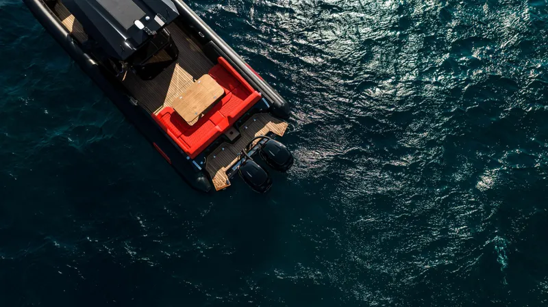 Slide: The Image of Aerial view of 2024 Skipper-BSK 38NC boat with red seating on blue water. - 3