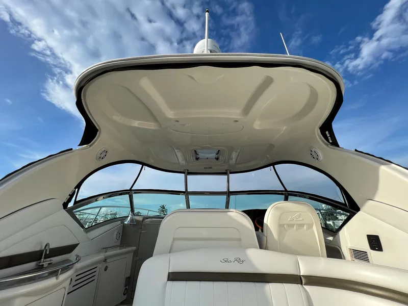 Slide: The Image of 2007 Sea Ray 40 Sundancer boat interior with white seating and blue sky background. - 13