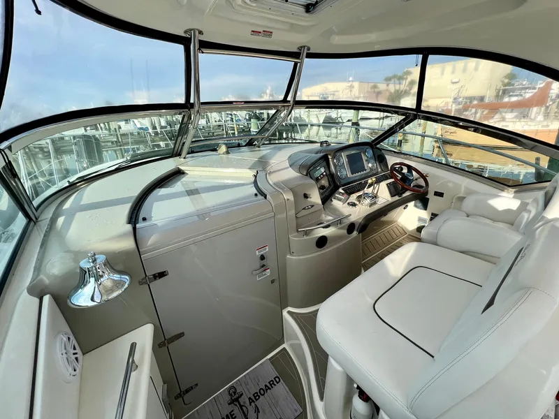 Slide: The Image of Cockpit of 2007 Sea Ray 40 Sundancer with modern navigation equipment and white seating. - 15