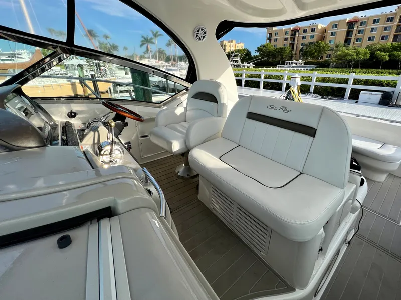 Slide: The Image of 2007 Sea Ray 40 Sundancer yacht interior with white seating and helm station. - 16