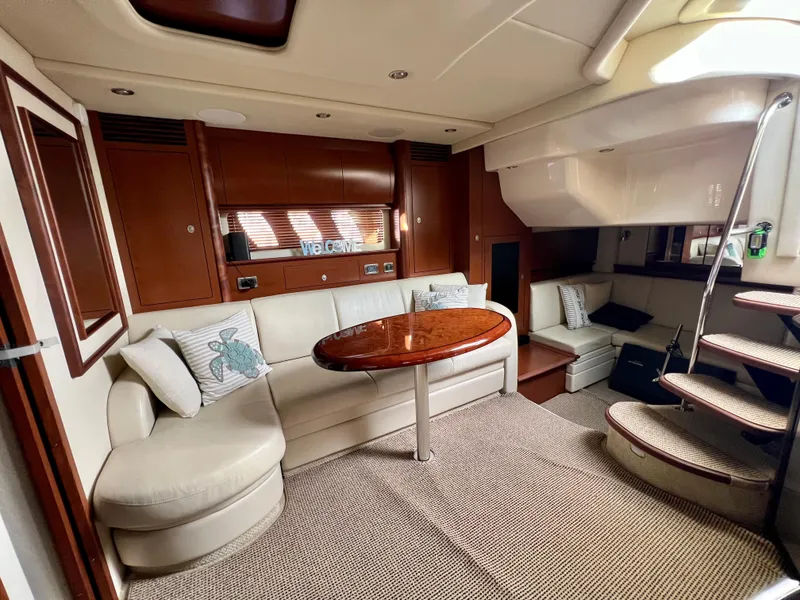 Slide: The Image of Luxurious interior of 2007 Sea Ray 40 Sundancer yacht with plush seating and wooden table. - 25