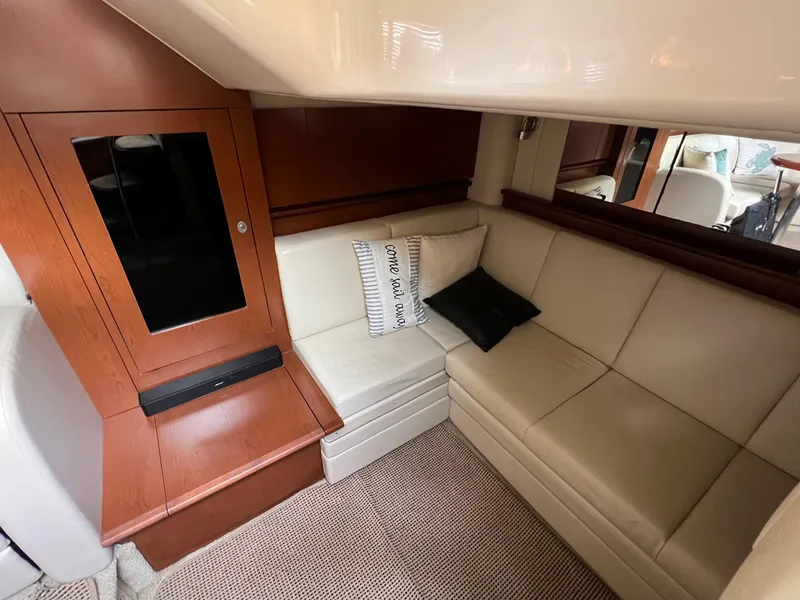Slide: The Image of 2007 Sea Ray 40 Sundancer interior with beige leather seating and wooden cabinetry. - 29