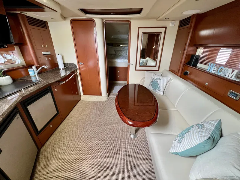 Slide: The Image of Interior of 2007 Sea Ray 40 Sundancer yacht with kitchen and seating area. - 31