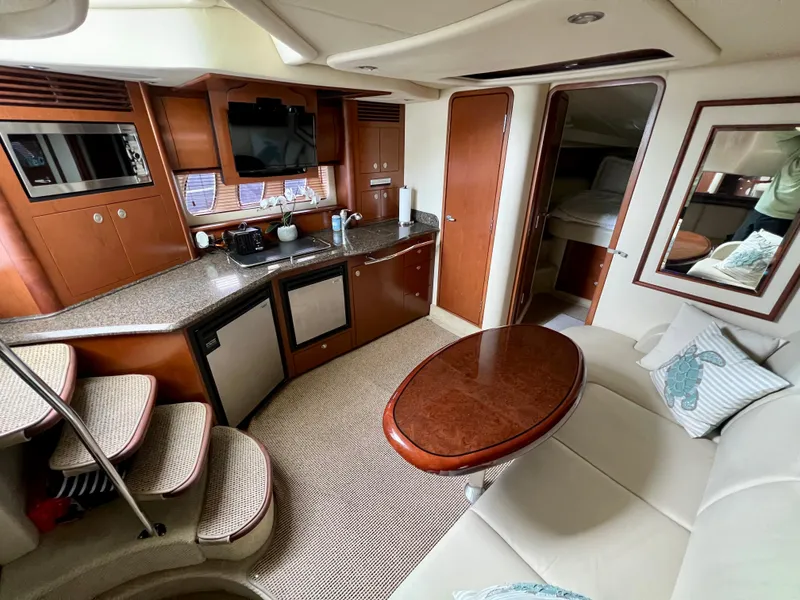Slide: The Image of Interior of 2007 Sea Ray 40 Sundancer yacht with kitchen and seating area. - 32