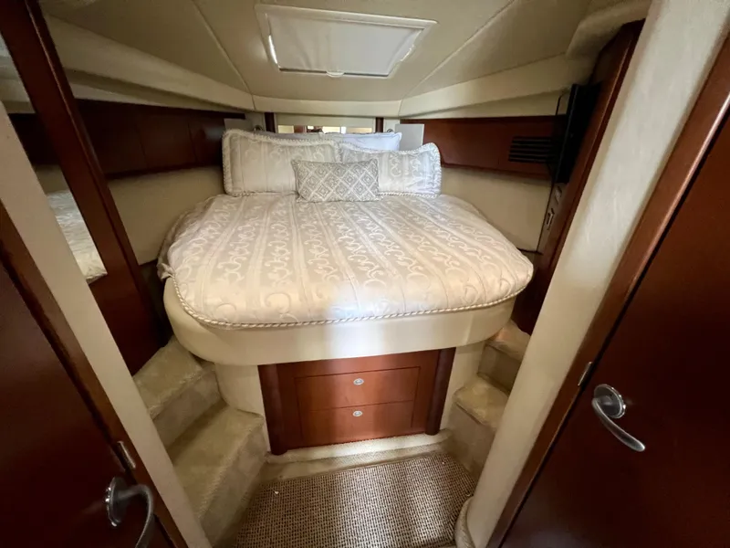 Slide: The Image of 2007 Sea Ray 40 Sundancer cabin with a cozy bed and wooden cabinetry. - 36