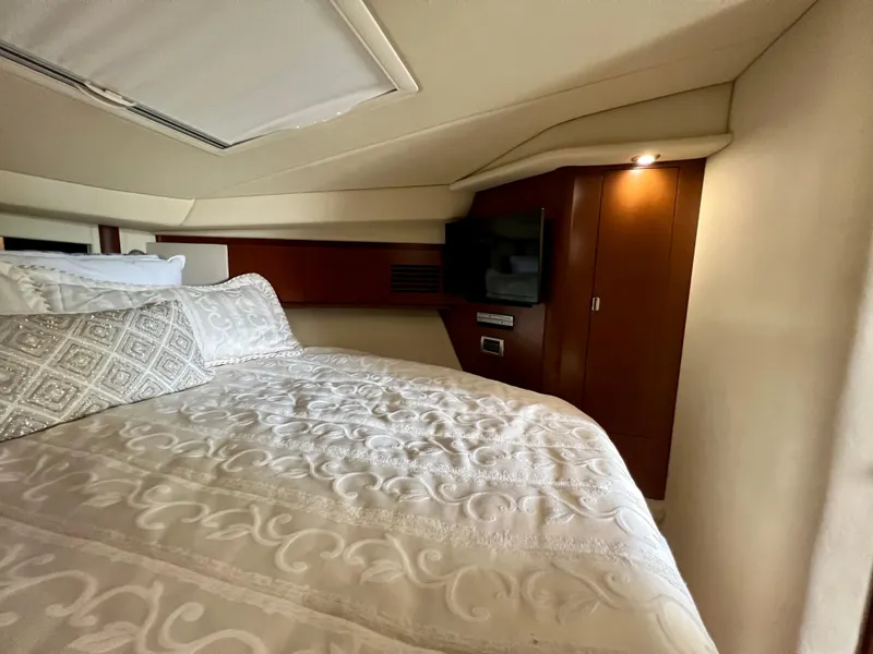 Slide: The Image of Luxurious bedroom interior of 2007 Sea Ray 40 Sundancer yacht with TV and elegant bedding. - 37