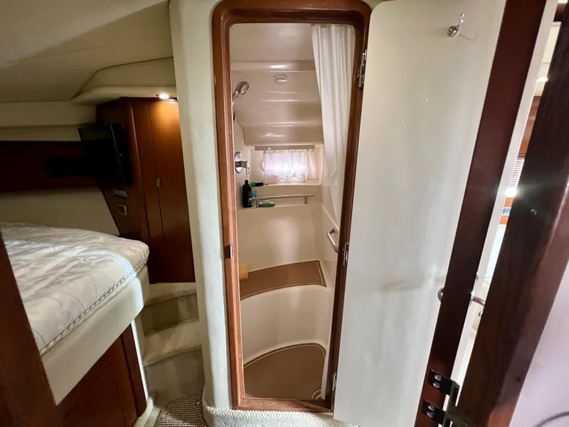 Slide: The Image of Interior cabin of 2007 Sea Ray 40 Sundancer yacht, featuring a cozy bedroom and bathroom. - 44