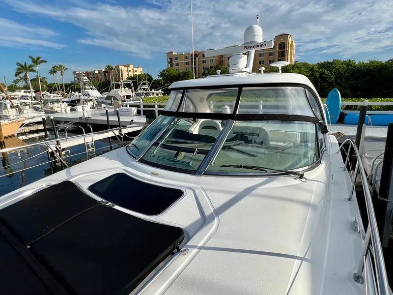 Slide: The Image of 2007 Sea Ray 40 Sundancer yacht docked at a marina with clear skies. - 7