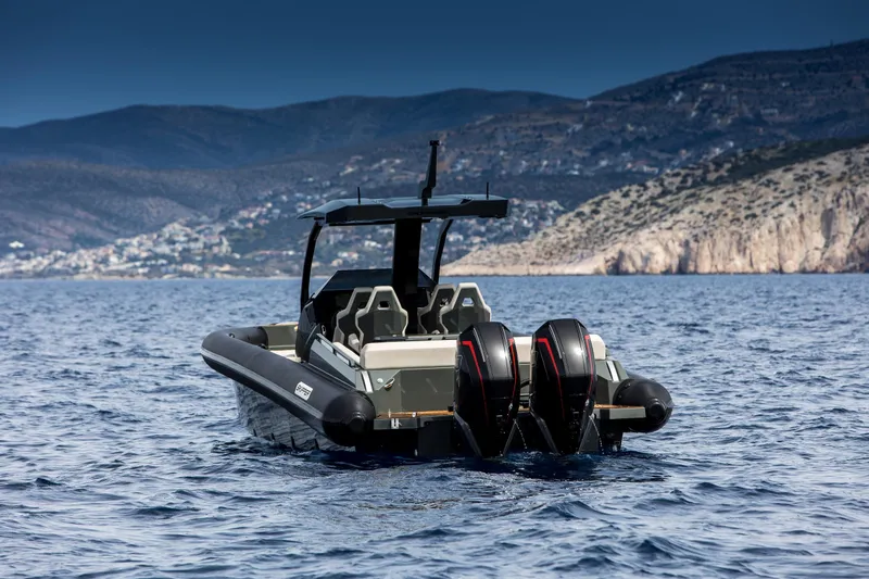 Slide: The Image of 2024 Skipper-BSK 38NC boat on open water with mountainous background. - 18