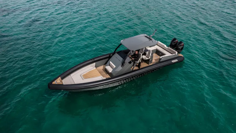 Slide: The Image of 2024 Skipper-BSK 38NC boat cruising on clear blue water. - 20