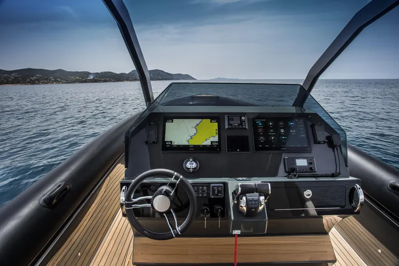 Slide: The Image of 2024 Skipper-BSK 38NC boat dashboard with navigation system on open water. - 24