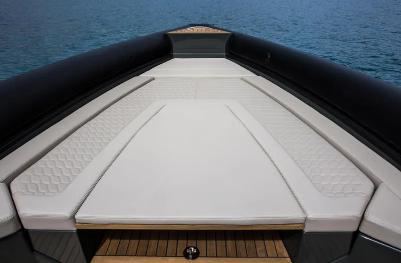Slide: The Image of 2024 Skipper-BSK 38NC boat with spacious cushioned deck on calm water. - 32
