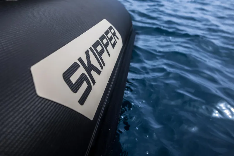 Slide: The Image of 2024 Skipper-BSK 38NC boat on water, close-up of logo. - 33