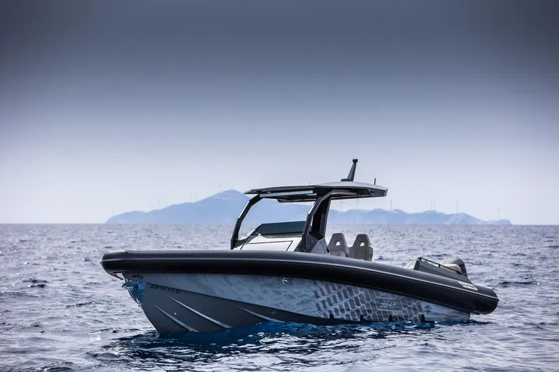 Slide: The Image of 2024 Skipper-BSK 38NC boat on open water with distant islands. - 15