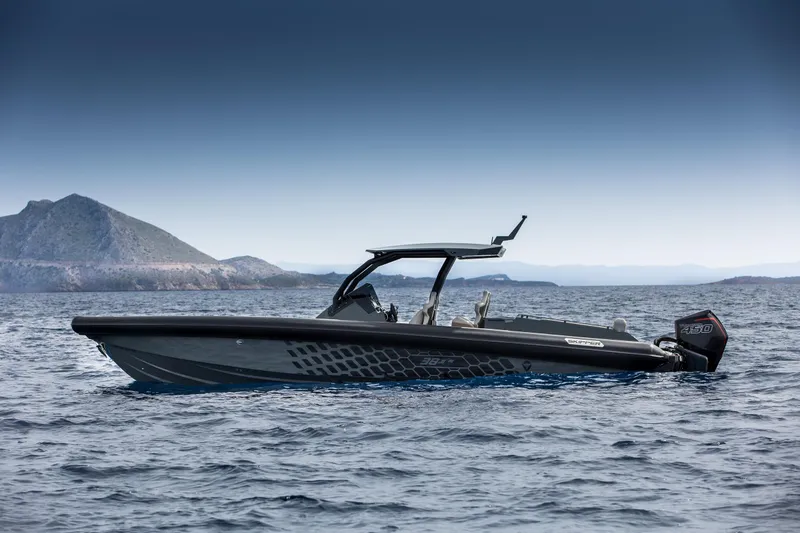 Slide: The Image of 2024 Skipper-BSK 38NC boat cruising on open water with mountainous background. - 16